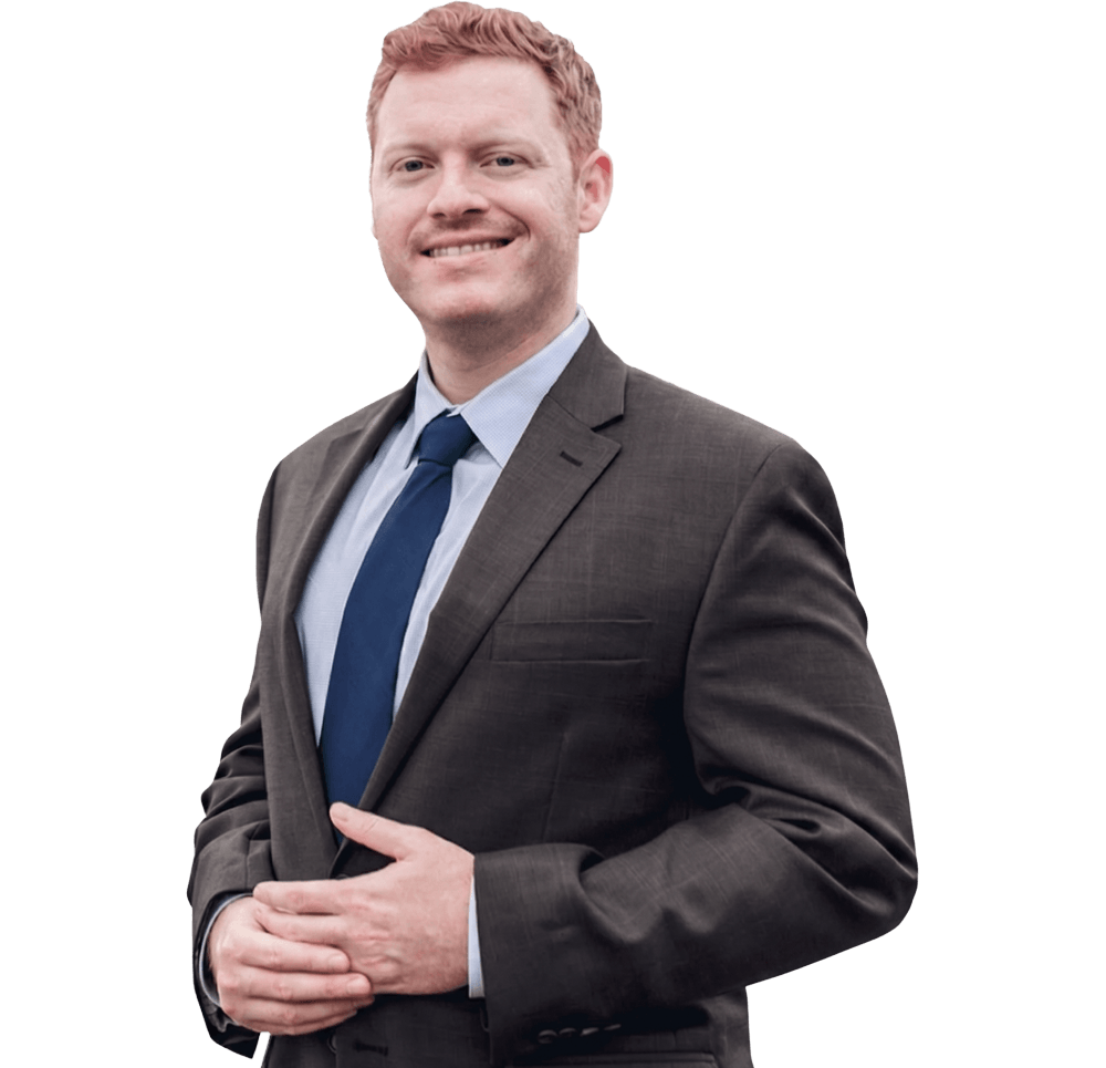Will Clark in business suit smiling confidently at the camera, isolated on white background.