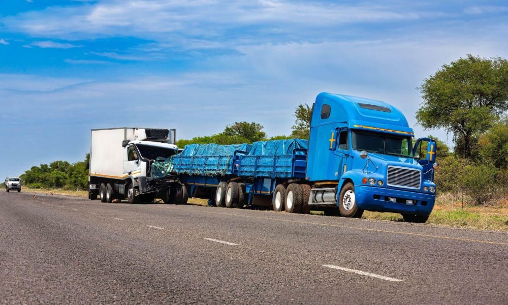 a semi truck hauling a semi trailer down a road
