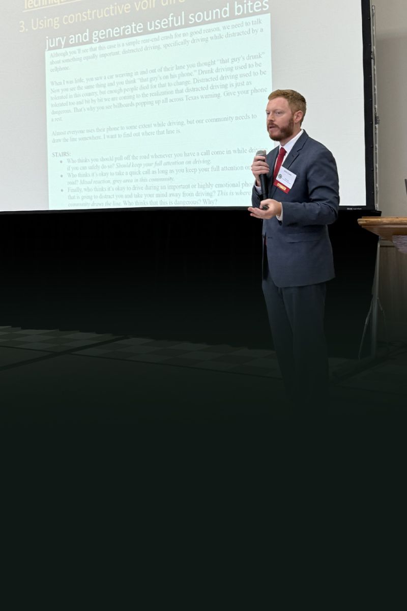 Man in suit presenting at a conference, discussing jury engagement in courtroom settings.
