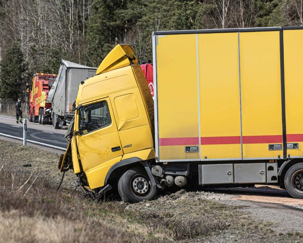 a yellow truck that is sitting on the side of the road