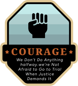 A badge features a raised fist icon above the word "COURAGE" in bold. Below, text reads: "We Don’t Do Anything halfway. we’re Not Afraid to Go to Trial When Justice Demands It."