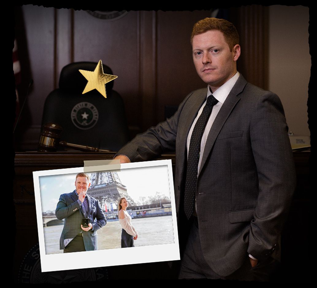Man in a suit stands in courtroom with a photo of a couple near the Eiffel Tower.
