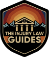 Shield logo for The Injury Law Guides, featuring mountains, a courthouse, and scales of justice.