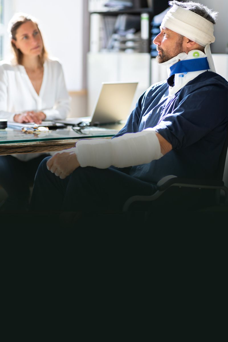 Man with injuries in neck brace and bandages in doctor consultation.