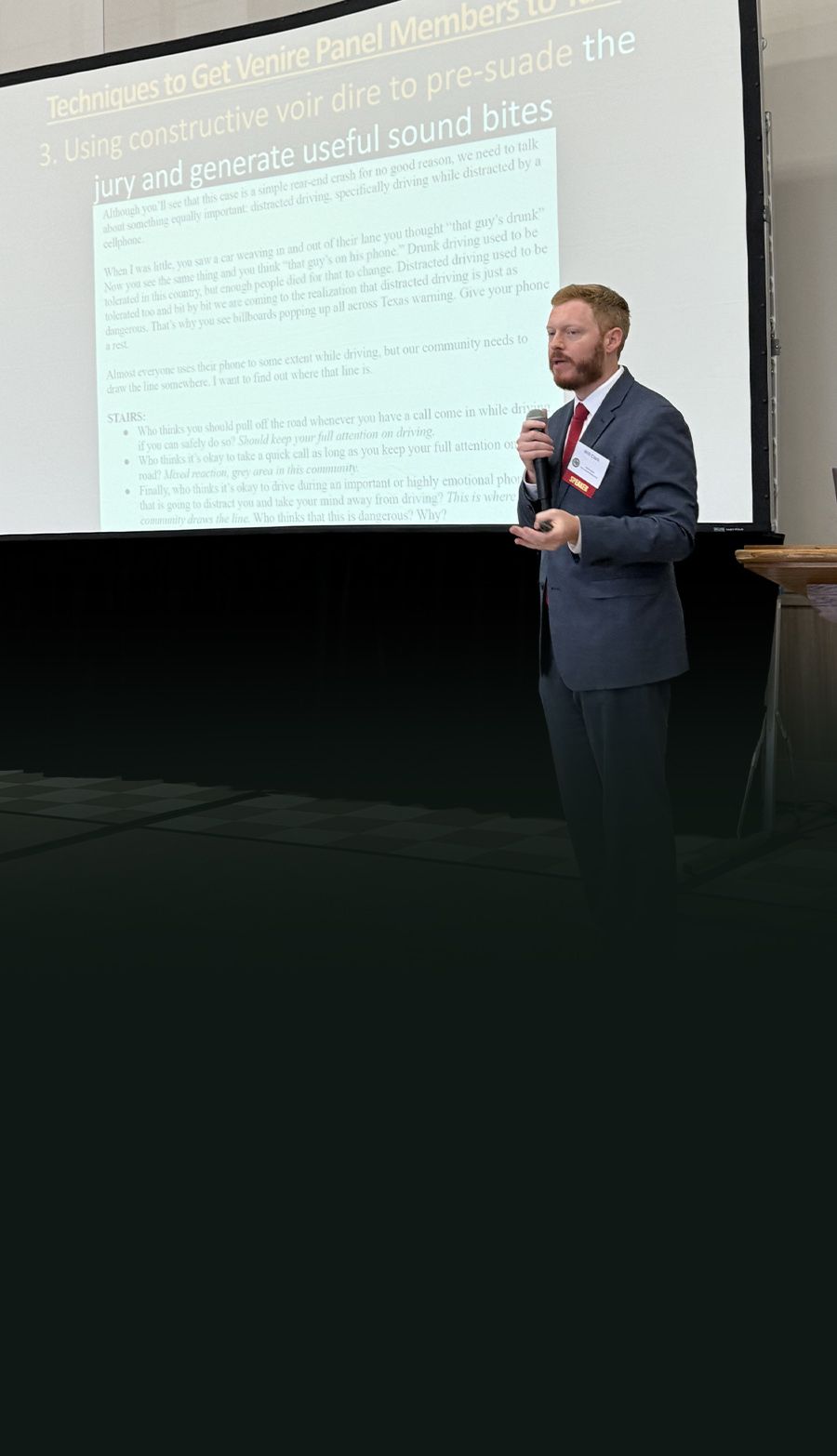 Man in suit presenting at a conference, discussing jury engagement in courtroom settings.