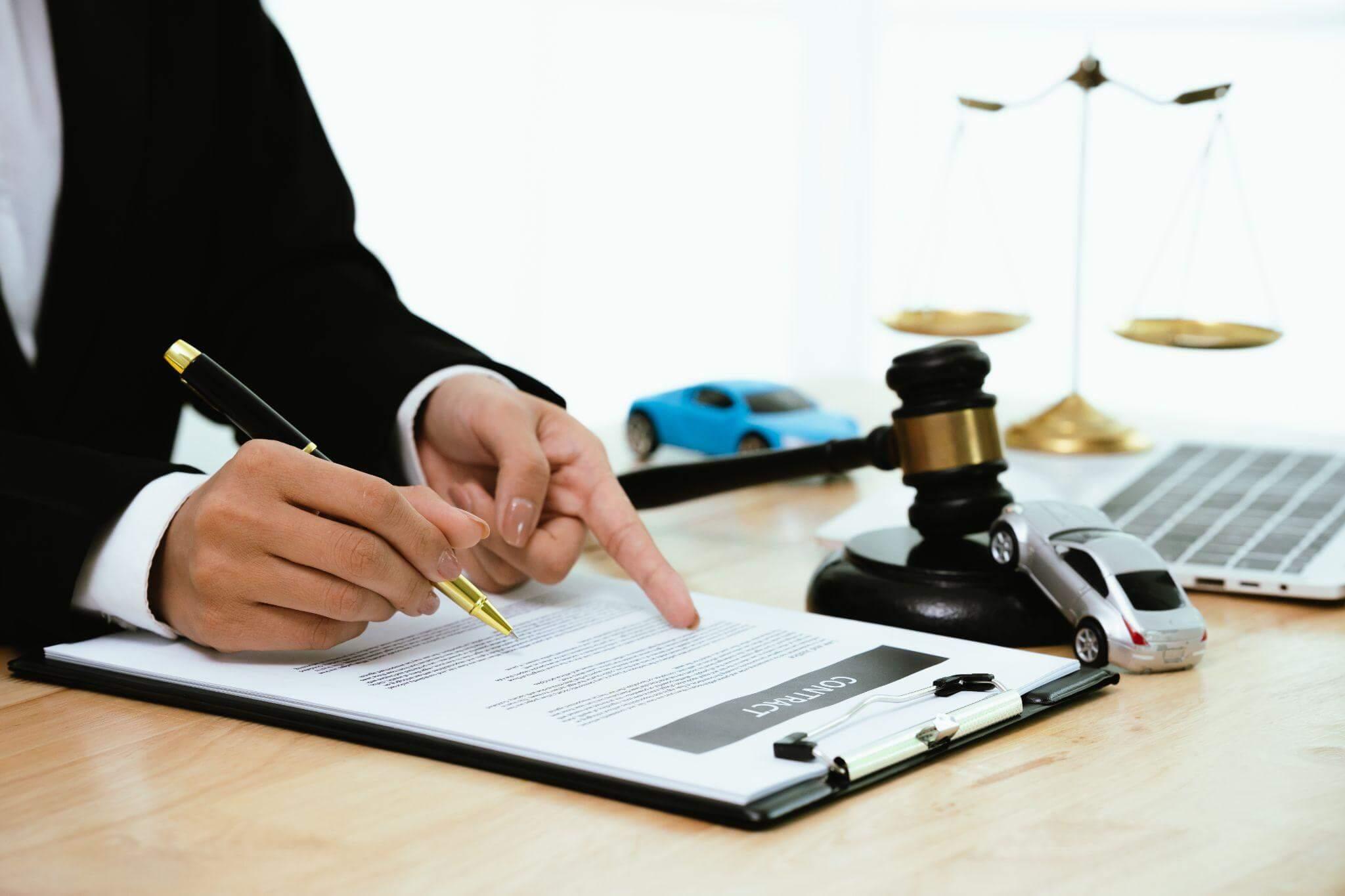 a person sitting at a desk in front of a law book